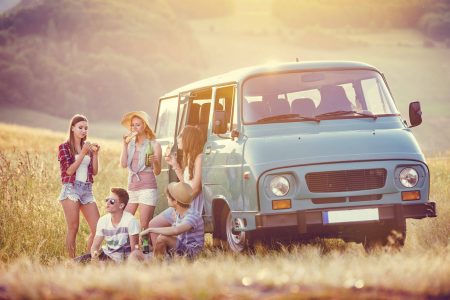 Young hipster friends on road trip on a summers day